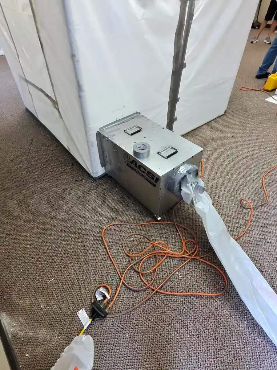 Dehumidifier ducted into a sealed containment during structural drying