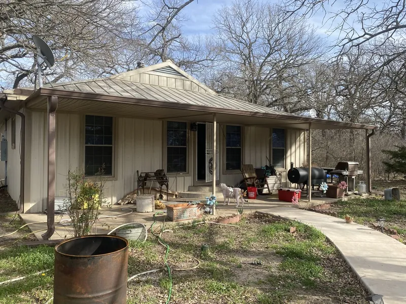 Home exterior with worn porch before remodel
