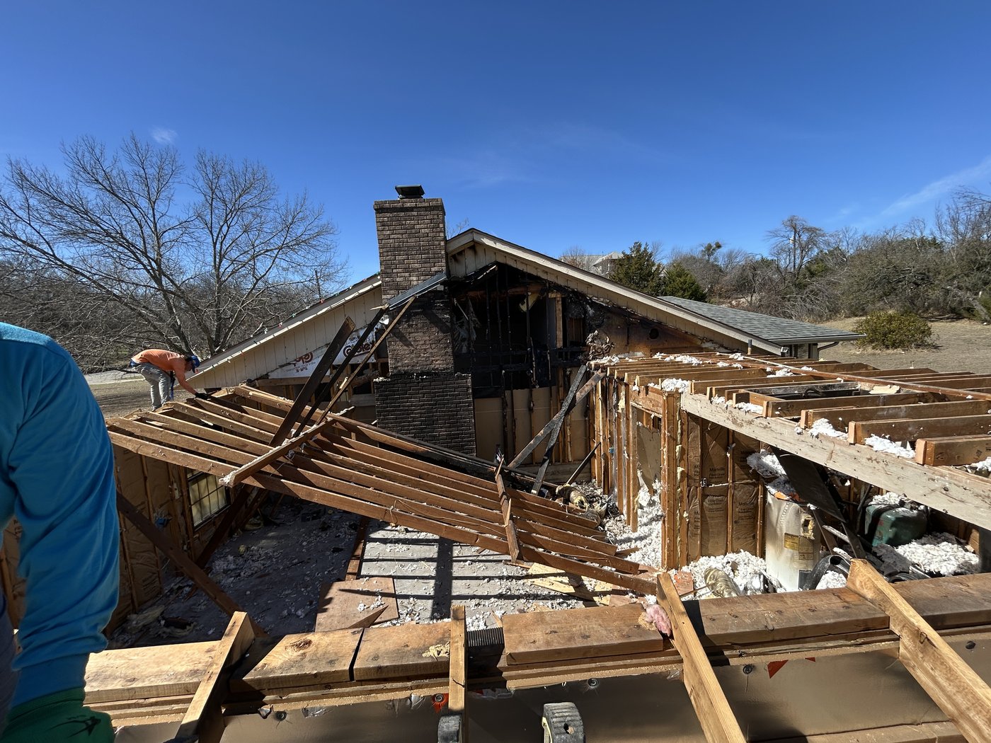 Fire damage to roof structure and chimney chase during cleanup and repair