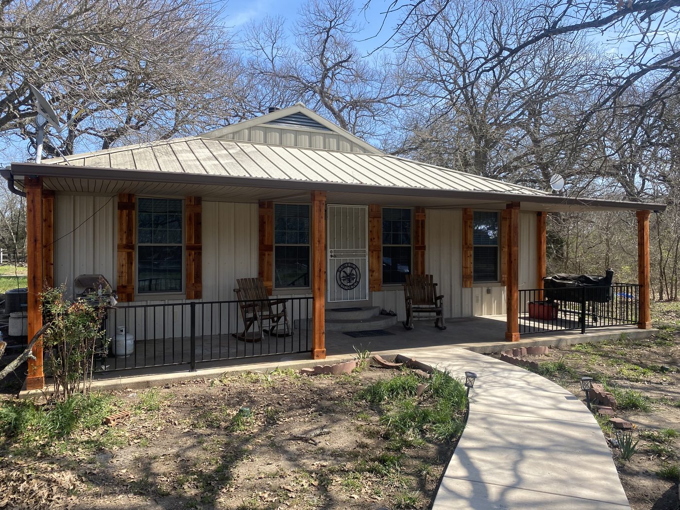 Porch rebuild with new cedar columns and railing - after